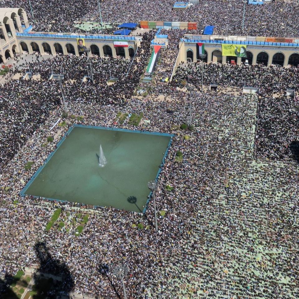 A crowd of people listening to Supreme Leader of Iran Ayatollah Ali Khamenei as he speaks during the Friday prayer ceremony in Tehran