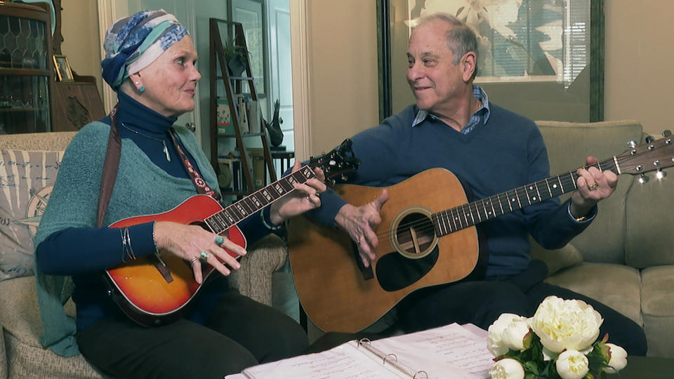 Lynda Shannon Bluestein, left, jams with her husband, Paul, in the living room of their home, Feb. 28, 2023, in Bridgeport, Conn. “Please do not make the end of life harder for me,” wrote Bluestein, 75, to the Drug Enforcement Agency. In March, Bluestein, who has terminal fallopian tube cancer, reached a settlement with the state of Vermont that will allow her to be the first non-resident to use its medically assisted suicide law. By the time she’s ready to use the drugs, she expects to be too ill to travel to see a doctor in person for the prescription, she wrote. (AP Photo/Rodrique Ngowi)