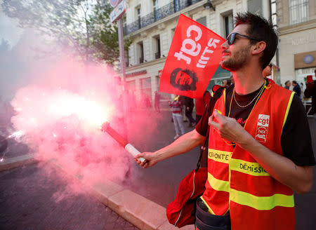 A CGT labour union holds a flare during a demonstration against the French government’s reform plans in Marseille as part of a national day of protest, France, April 19, 2018. REUTERS/Jean-Paul Pelissier