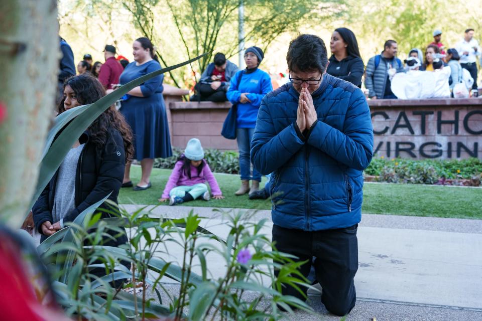 Luciano Giacometti kneels and prays during Mass on Dec. 2, 2023, outside St. Mary's Basilica to celebrate the feast day of Our Lady of Guadalupe in Phoenix. The feast day is on Dec. 12.