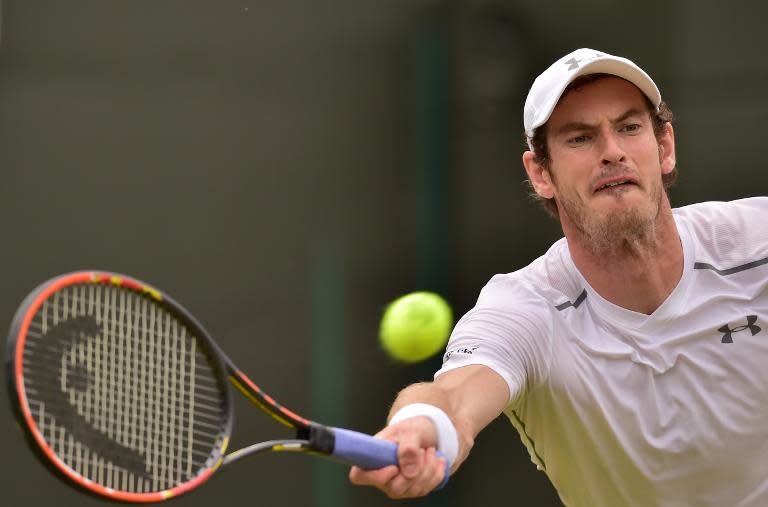 Britain's Andy Murray returns against Netherlands' Robin Haase during the men's singles second round match on day four of the 2015 Wimbledon Championships at The All England Tennis Club in Wimbledon, southwest London, on July 2, 2015. RESTRICTED TO EDITORIAL USE -- AFP PHOTO / LEON NEAL