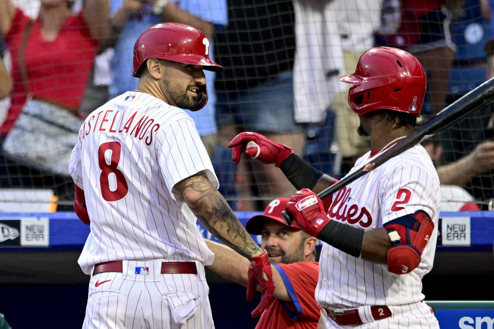 Philadelphia Phillies' Nick Castellanos (8) celebrates his solo home run with Jean Segura during the third inning of a baseball game against the Pittsburgh Pirates, Saturday, Aug. 27, 2022, in Philadelphia. (AP Photo/Derik Hamilton)