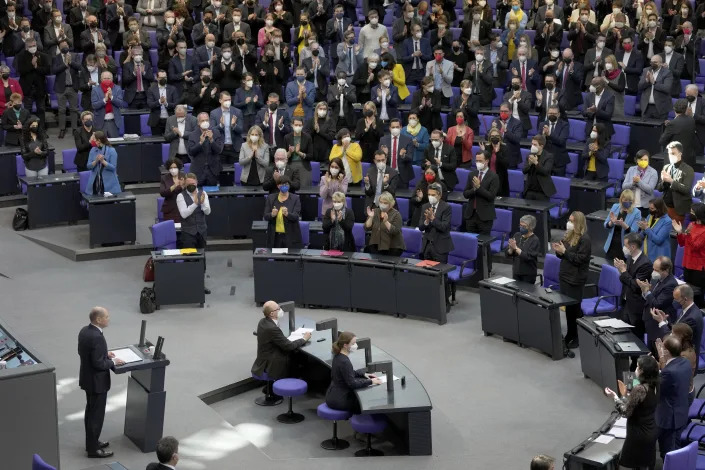 Lawmaker applaude during German Chancellor Olaf Scholz' speech on the Russian invasion of the Ukraine during a meeting of the German federal parliament, Bundestag, at the Reichstag building in Berlin, Germany, Sunday, Feb. 27, 2022. (AP Photo/Michael Sohn)