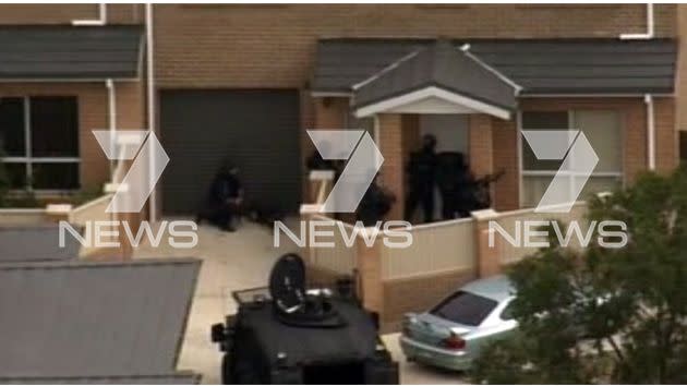 Footage captured by the 7News chopper shows heavily-armed tactical officers surrounding the property. Photo: 7News