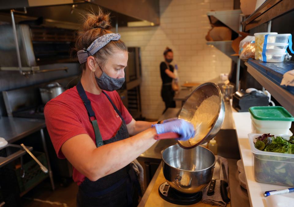 Caroline Glover, the chef-owner of Annette Scratch to Table restaurant in Aurora, Colorado, prepares dough for baking during the coronavirus outbreak.