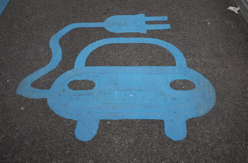 A logo depicting an electric car is seen on the floor of a charging bay inside an ALDI supermarket car park in Manchester, Britain