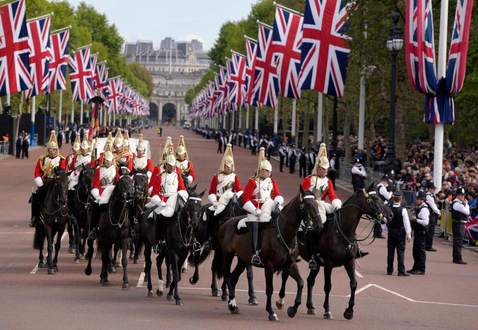 Mounted Household Cavalry ride along the route prior to the procession of the Gun Carriage which will carry the coffin of Queen Elizabeth II from Buckingham Palace to Westminster Hall in London, Wednesday, Sept. 14, 2022