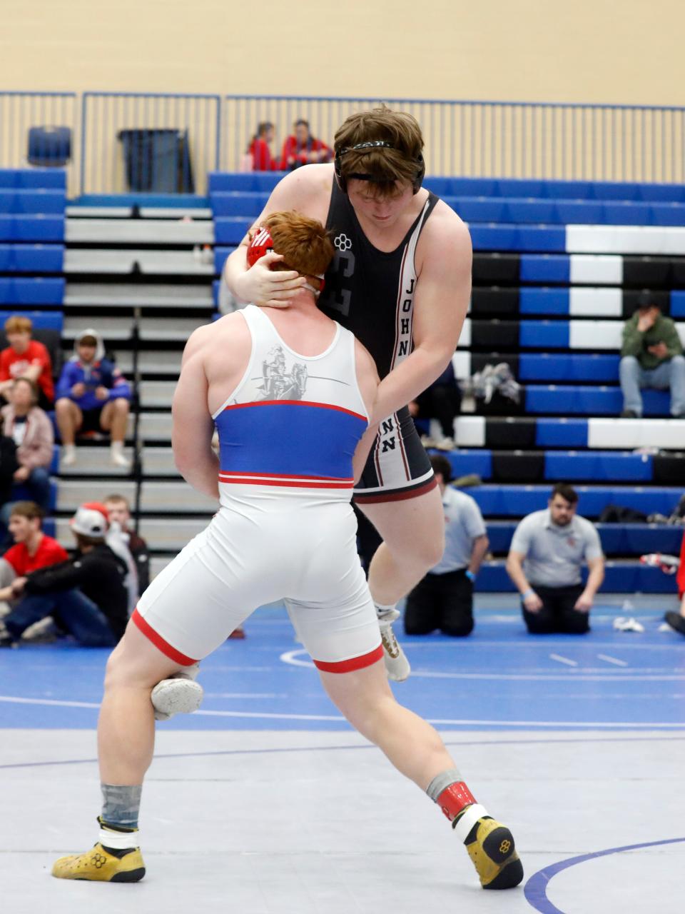 John Glenn sophomore Kian Barton wrestles West Holmes' Grant Miller, left, in the third-place match at 215 pounds during the Division II district wrestling tournament on Saturday at Gallia Academy High School in Gallipolis. Barton was one of four Muskies to qualify for the state tournament at Ohio State.