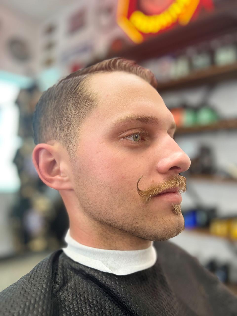 Wyatt McCoy just had his mustache trimmed Friday, Oct. 28, 2023 by Steve Vilot of Barber Authority in Lynchburg, Tenn.