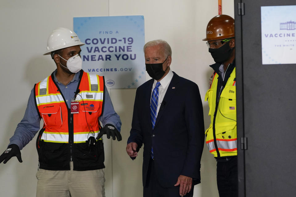 President Joe Biden tours a Clayco Corporation construction site for a Microsoft data center in Elk Grove Village, Ill., Thursday, Oct. 7, 2021, with Anuraj Jhajj of Microsoft, left, and Otto Nichols of Clayco. (AP Photo/Susan Walsh)