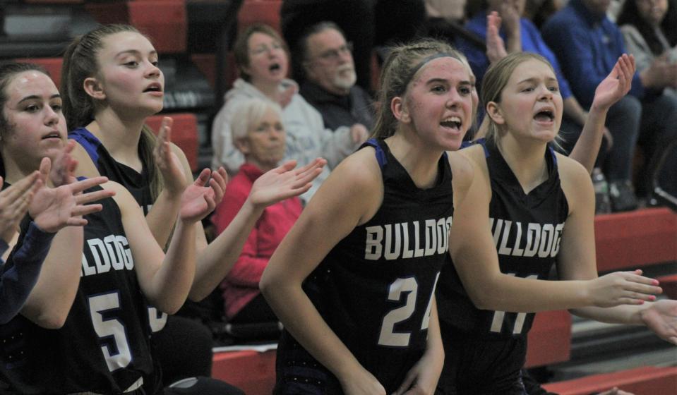 Inland Lakes players celebrate from the bench after a made basket during the second half against NMCA on Wednesday.