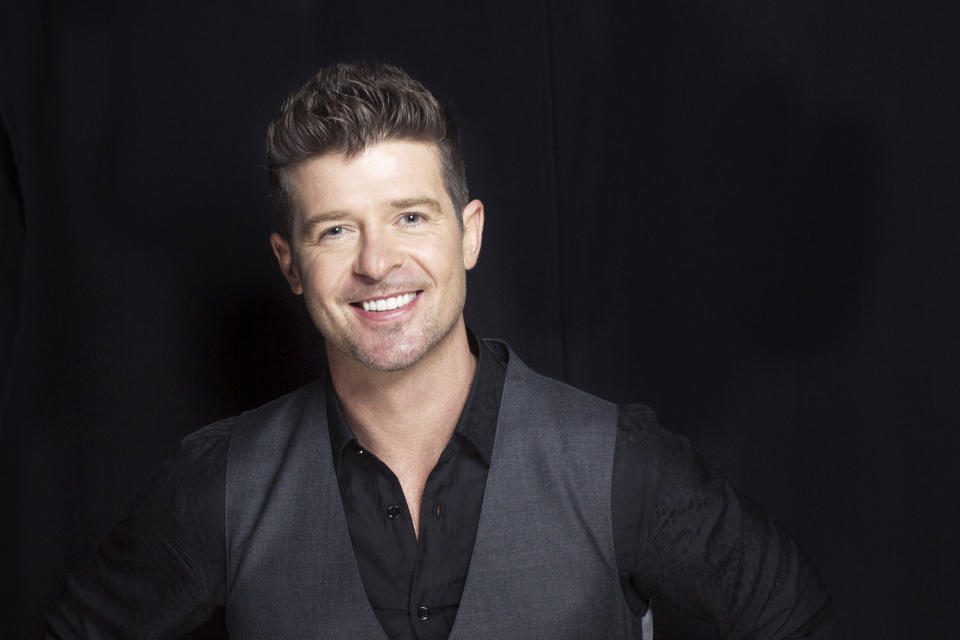 This Aug. 1, 2013 photo shows R&B singer-songwriter Robin Thicke in New York. Thicke released his fifth album, "Blurred Lines," on Aug. 2. The title track and lead single, which features T.I. and Pharrell, is the longest-running No. 1 song on the Billboard Hot 100 chart so far this year. (Photo by Victoria Will/Invision/AP)