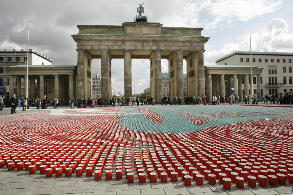 FILE - In this Monday, Sept. 29, 2008 file photo, 77,000 cups sit in front of the Brandenburg Gate in Berlin for use in a television show to illustrate how many cups of coffee the average German drinks during their lifetime. A large U.S. federal study concludes people who drink coffee seem to live a little longer. Researchers saw a clear connection between cups consumed and years of life. Whether it was regular or decaf didn't matter. The results are published in the Thursday, May 17, 2012 New England Journal of Medicine. (AP Photo/Herbert Knosowski)