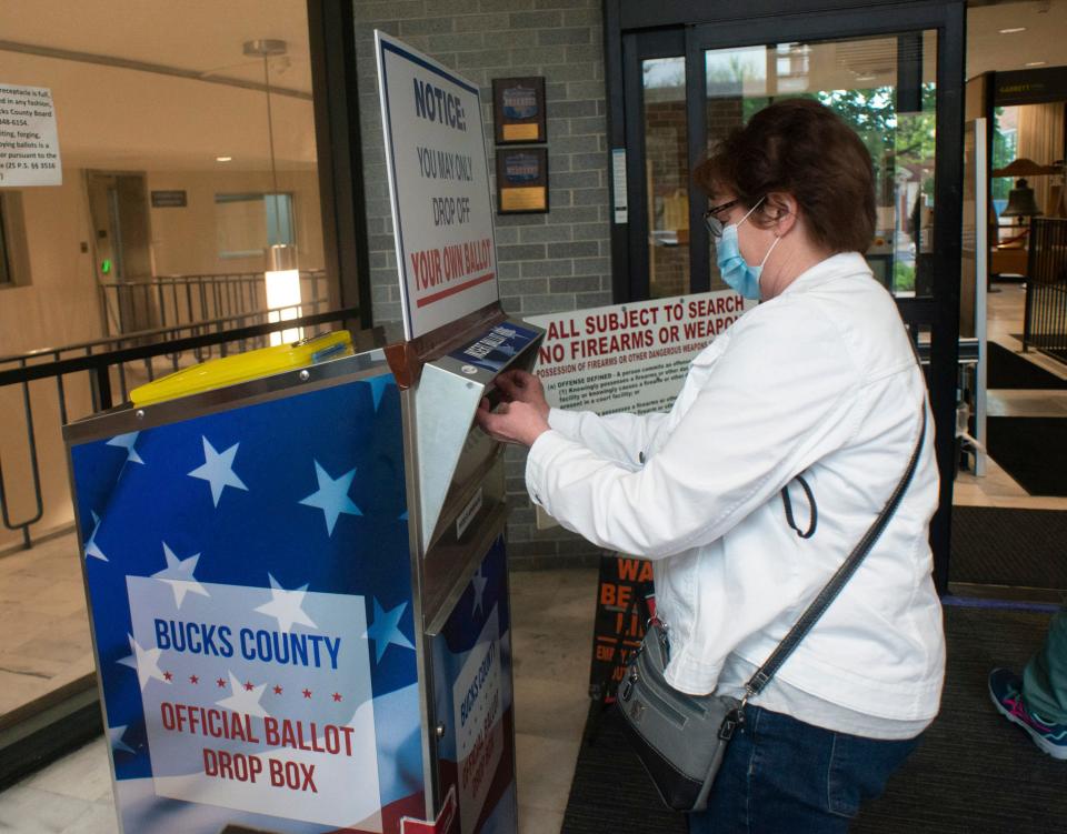 File - Marchelle Roll of Buckingham leaves her ballot in the box as voters start to return their mail in ballots to the county drop box Friday, May 13, 2022 at Bucks County Administration Building in Doylestown.