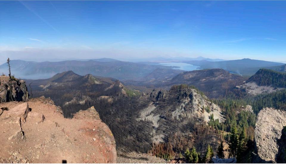 A view from Fuji Mountain of the Cedar Creek Fire burn scar, showing a mosaic of low, moderate, and high burn severity, with Waldo Lake in the distance.