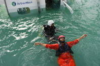 Ron Profitt, a former police officer, below, takes a helicopter safety course by 3t EnterMech for ExxonOil, where he now works, in Georgetown, Guyana, Tuesday, April 11, 2023. It’s rare for Guyanese to work directly in the oil industry, as the work to dig deep into the ocean floor is highly technical, and the country doesn't offer such training. (AP Photo/Matias Delacroix)