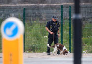 <p>A police officer with a sniffer dog patrols near the Manchester Arena in Manchester, England Tuesday, May 23, 2017.(Danny Lawson/PA via AP) </p>