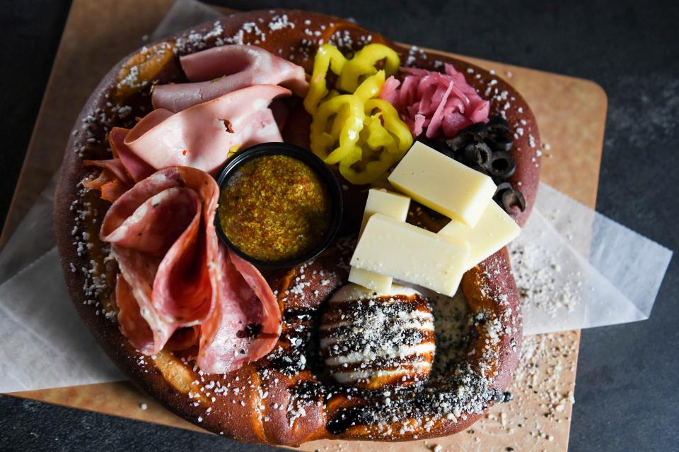 Main Street Pub management introduces the bougie pretzel to the menu in Spartanburg, S.C., on Wednesday, April 10, 2024. The bougie is the Pub management's take on a charcuterie board served with a soft pretzel.