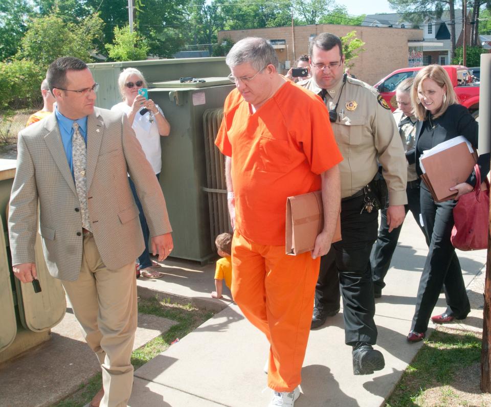 Bernie Tiede, right, is escorted by Panola County Sheriff Kevin Lake, left, and other deputies Tuesday, May 6, 2014, after his hearing at the Panola County Courthouse in Carthage.
