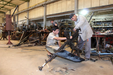 Libyan volunteers fix weapons belonging to the members of the Libyan internationally recognised government forces at a workshop in Misrata, Libya May 2, 2019. REUTERS/Ayman al-Sahili