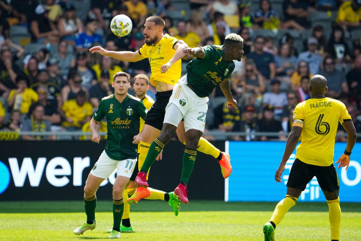 Sep 18, 2022; Columbus, Ohio, USA; Columbus Crew defender Milos Degenek (5) heads a ball away from Portland Timbers forward Dairon Asprilla (27) during the second half of the MLS game at Lower.com Field. The Crew and Timbers tied 1-1. Mandatory Credit: Adam Cairns-The Columbus Dispatch