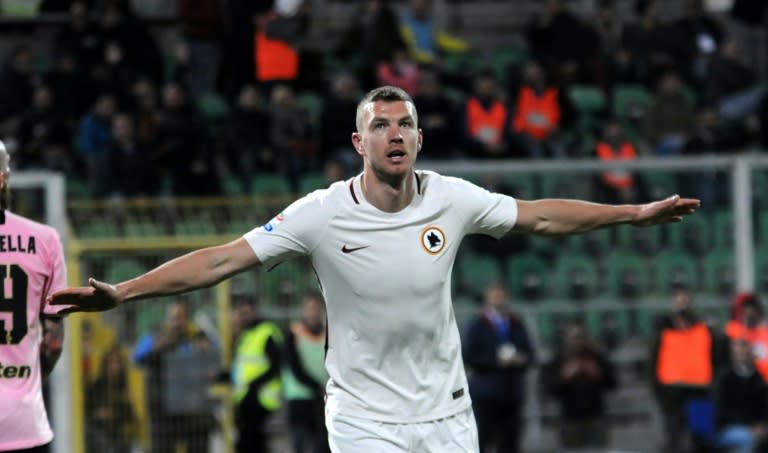 Roma's forward from Bosnia-Herzegovina Edin Dzeko celebrates after scoring during the Italian Serie A football match Palermo vs AS Roma, on March 12, 2017