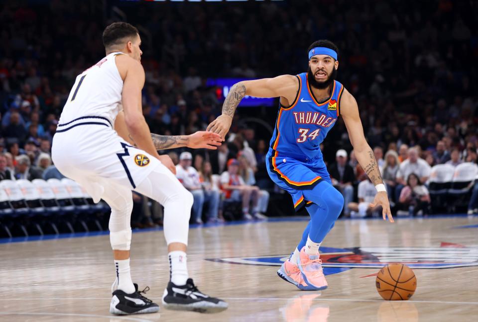 Oklahoma City Thunder forward Kenrich Williams (34) drives up court as Denver Nuggets forward Michael Porter Jr. (1) defends in an NBA basketball game between the Oklahoma City Thunder and the Denver Nuggets at Paycom Center in Oklahoma City, Wednesday, Jan. 31, 2024.