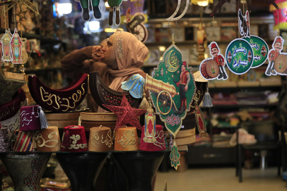 A woman shops for decorations in preparation for the upcoming Islamic holy month of Ramadan, in the southern port city of Sidon, Lebanon, Monday, March 28, 2022. (AP Photo/Mohammed Zaatari)