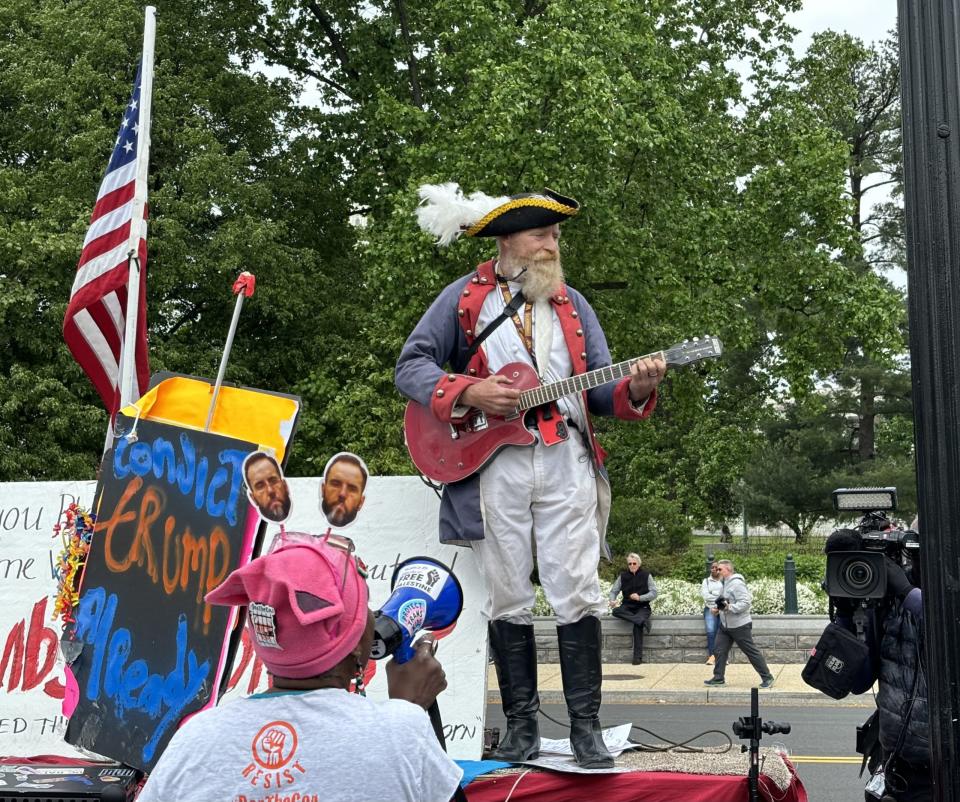 A supporter of former President Donald Trump, clad in colonial garb, led chants of "Vote for Trump," sang and argued with anti-Trump protesters April 25, 2024, outside the U.S. Supreme Court.