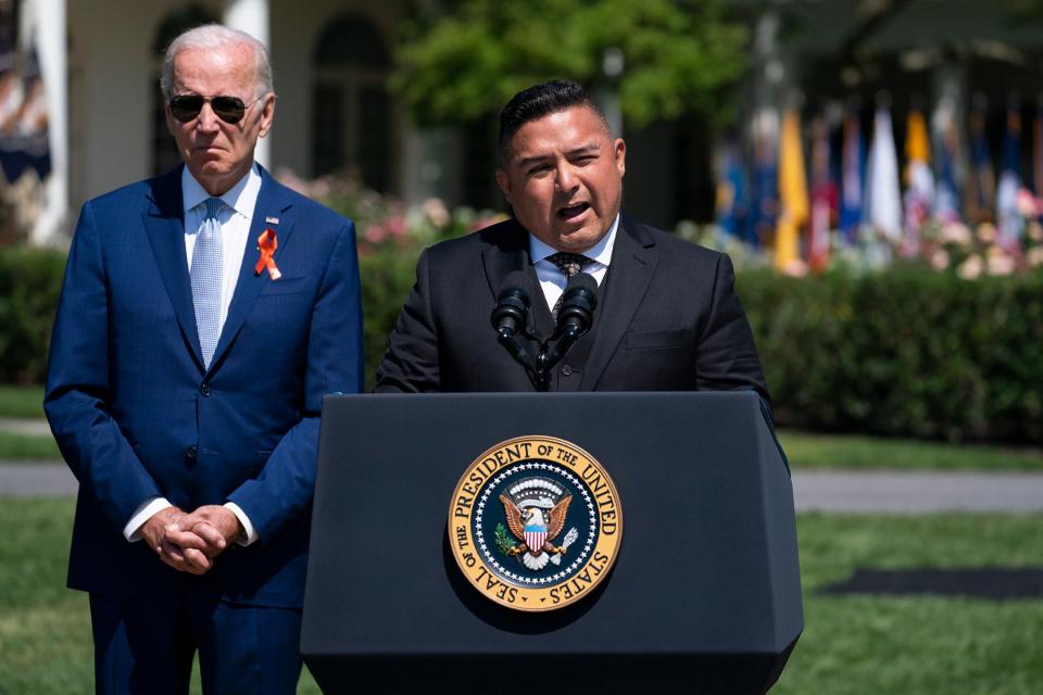 President Joe Biden listens as Dr. Roy Guerrero speaks during an event to celebrate the passage of the Bipartisan Safer Communities Act, a law meant to reduce gun violence, at the White House in July. “It’s been tough being a pediatrician in a community where children do not want to return to school, and parents don’t want to send them there, with the fear of a future attack,” Guerrero told the crowd.