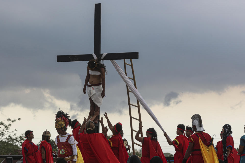 Ruben Enaje is lowered from the cross during the reenactment of Jesus Christ's sufferings as part of Good Friday rituals in San Pedro Cutud, north of Manila, Philippines, Friday, March 29, 2024. The Filipino villager was nailed to a wooden cross for the 35th time to reenact Jesus Christ’s suffering in a brutal Good Friday tradition he said he would devote to pray for peace in Ukraine, Gaza and the disputed South China Sea. (AP Photo/Gerard V. Carreon)