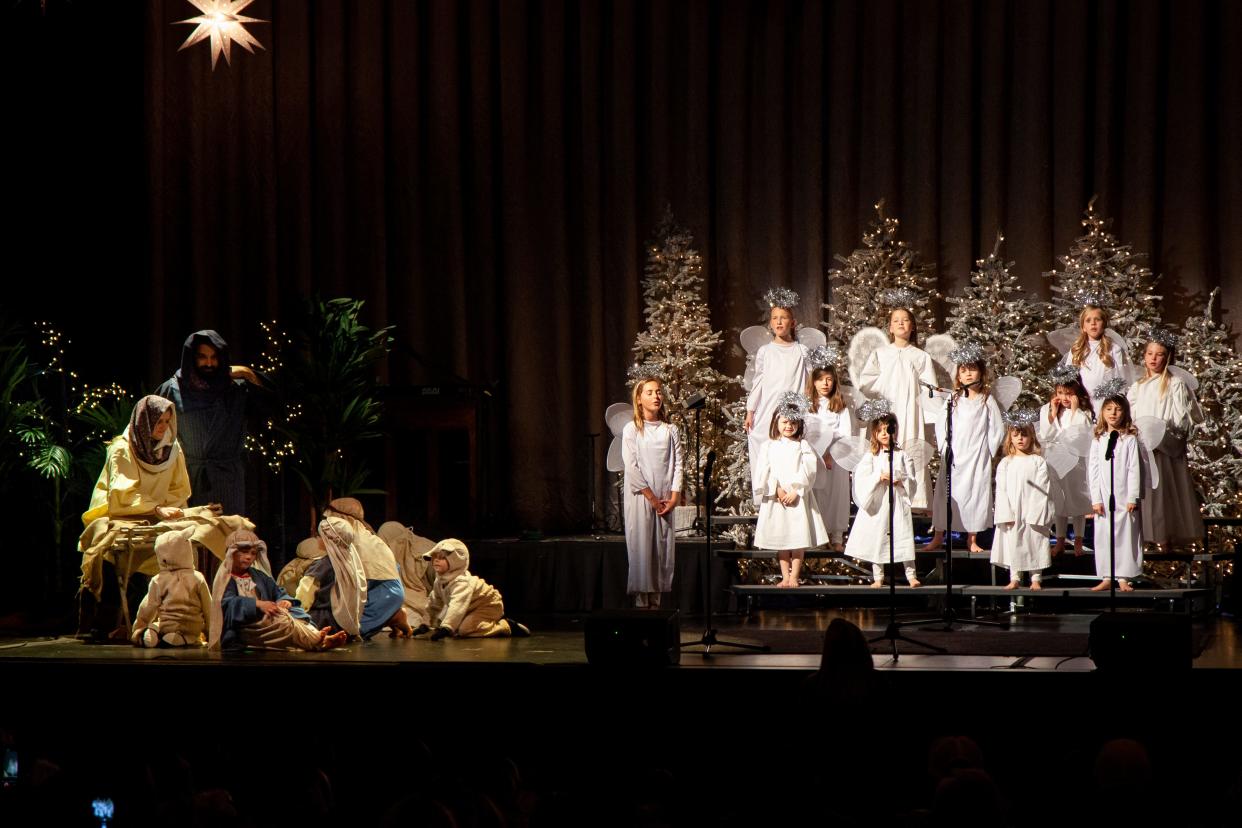 A Nativity scene is portrayed while a choir of angels sings nearby in "The Real Christmas Story" at Crossings Community Church, 14600 N Portland.