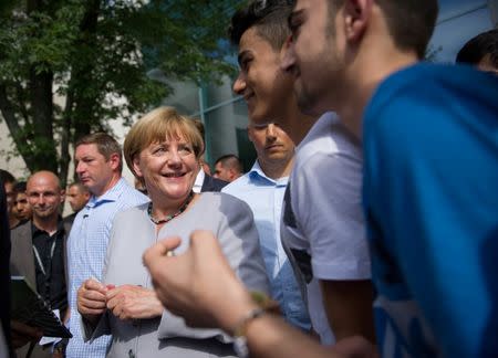 German Chancellor Angela Merkel meets visitors on tour during the open day at the Federal Chancellery in Berlin, Germany August 28, 2016. REUTERS/Stefanie Loos