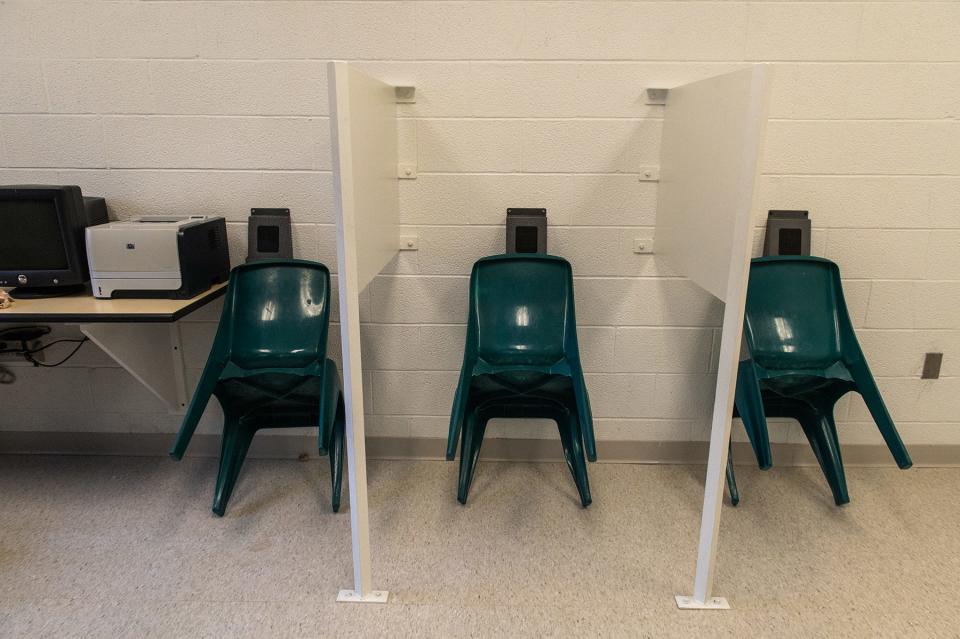 Chairs are leaned up against the wall in stalls where inmates can use tablets to make video visit calls in the multipurpose room in the housing unit A3 ICE pod at the Orange County Jail in Goshen on March 11, 2022.