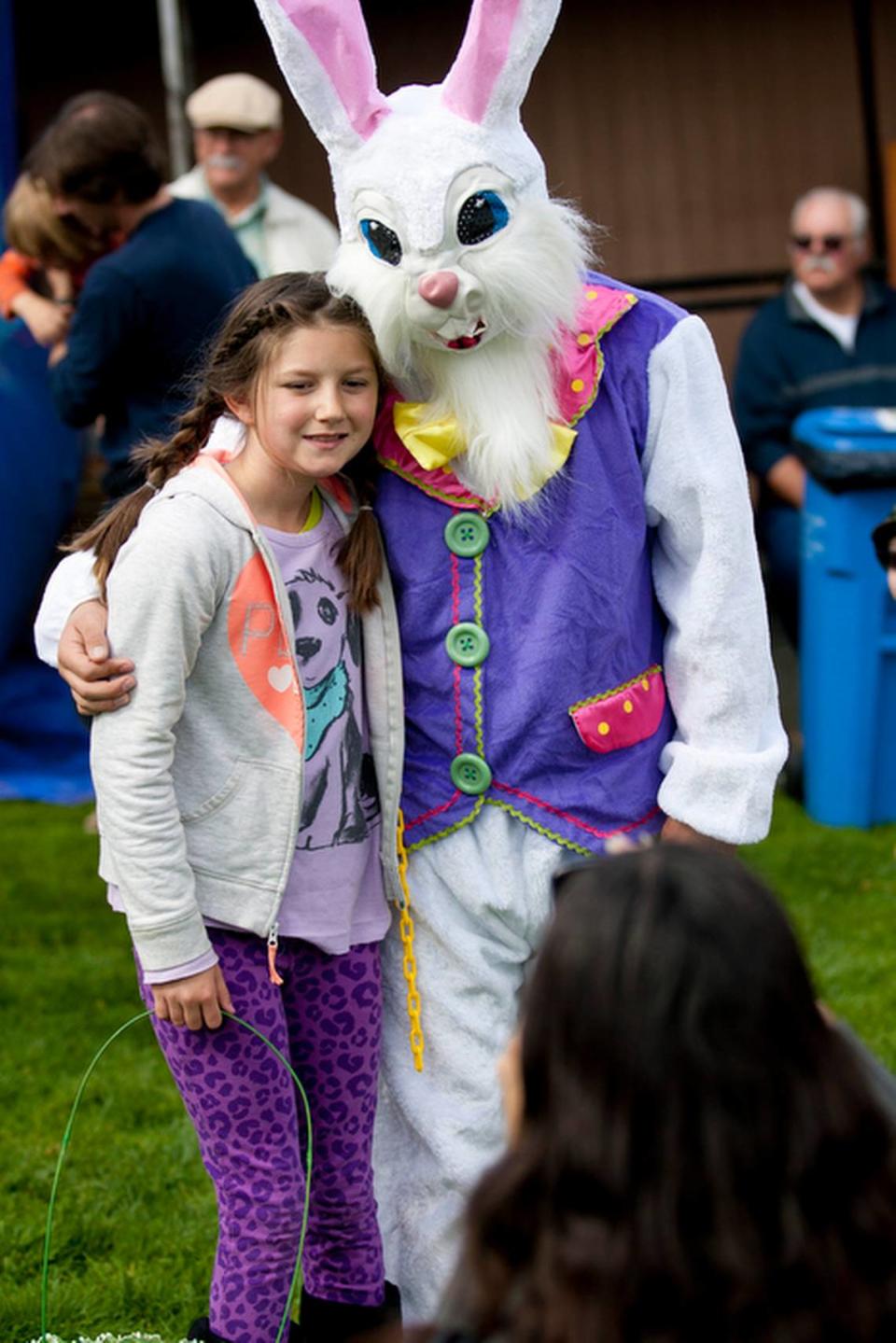 Julie Bundy of Dana Point, takes a photo of her daughter, Haley, 9 with the Easter Bunny at the South Bay Community Center in Los Osos in 2013. Egg hunts are scheduled across San Luis Obispo County in April 2023.