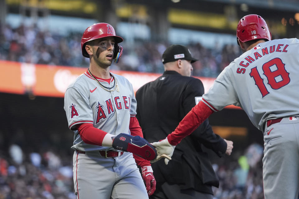 Los Angeles Angels' Zach Neto, left, celebrates with Nolan Schanuel (18) after scoring against the San Francisco Giants during the second inning of a baseball game Friday, June 14, 2024, in San Francisco. (AP Photo/Godofredo A. Vásquez)