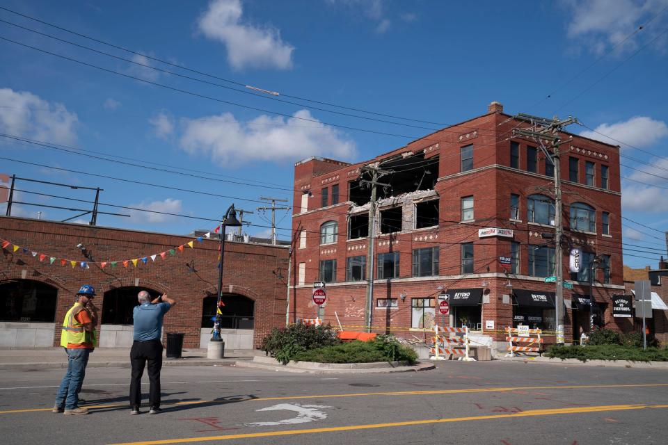 Paul Grout, right, talks to workers Tuesday, Sept. 19, 2023, about the building that partially collapsed in Eastern Market on Saturday, Sept. 16, 2023. Grout is hoping to help save the historic building.
