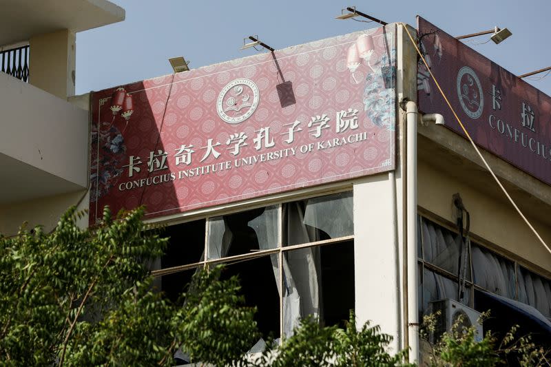 A general view shows broken window glasses, after a blast near a passenger van at the entrance of the Confucius Institute University of Karachi