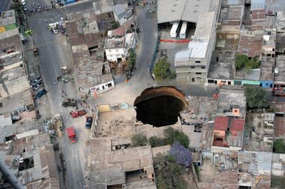 <b>Aerial view of the huge hole in Guatemala City after the sewage system collapsed. If you look at the surrounding buildings, you can see how big that scary sinkhole is.</b> Orlando Sierra/AFP/<a class="link " href="http://www.gettyimages.com/Home.aspx" rel="nofollow noopener" target="_blank" data-ylk="slk:Getty Images;elm:context_link;itc:0;sec:content-canvas">Getty Images</a>