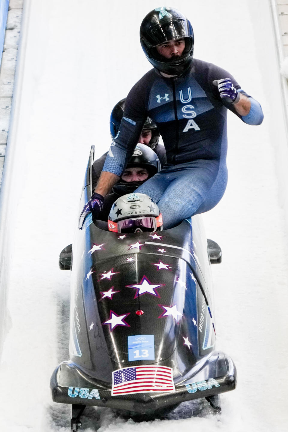 Hunter Church, Joshua Williamson, Kristopher Horn and Charlie Volker, of the United States, celebrate in the finish area after the 4-man heat 3 at the 2022 Winter Olympics, Sunday, Feb. 20, 2022, in the Yanqing district of Beijing. (AP Photo/Mark Schiefelbein)