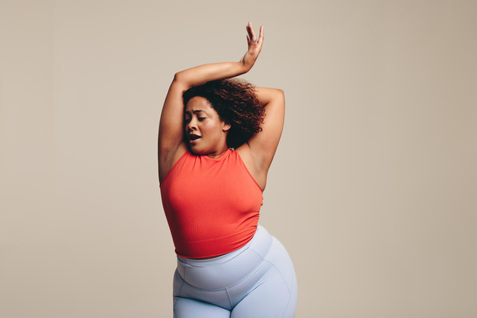 A woman with her arms above her head