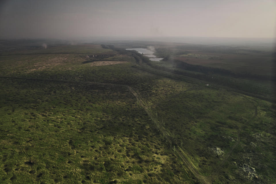 A field covered with bomb craters between the Ukrainian and Russian positions near Bakhmut, the site of fierce battles with the Russian forces in the Donetsk region, Ukraine, Sunday, Sept. 3, 2023. (AP Photo/Libkos)