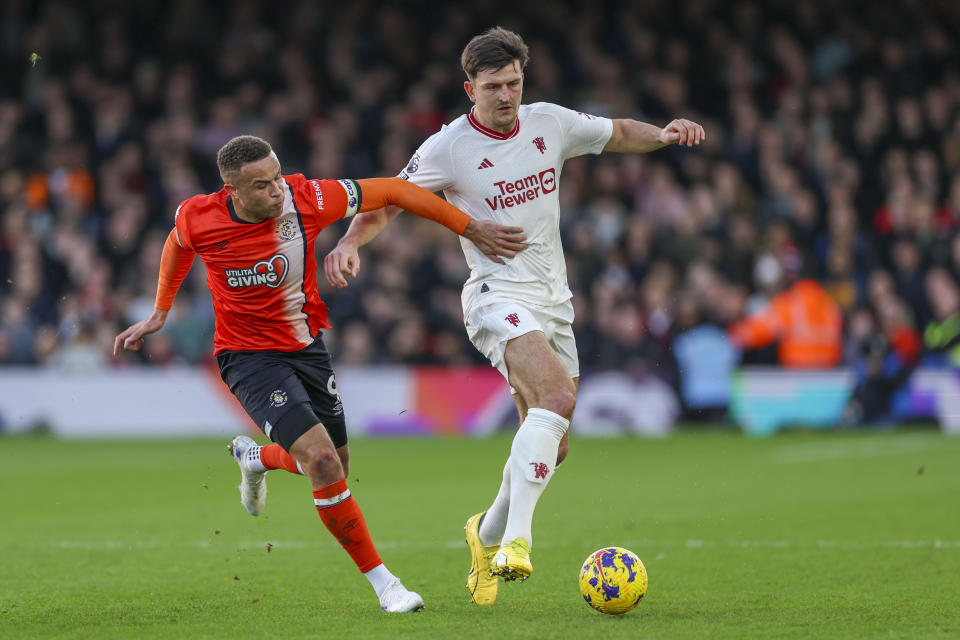 Manchester United's Harry Maguire, right, duels for the ball with Luton Town's Carlton Morris during the English Premier League soccer match between Luton Town and Manchester United at Kenilworth Road, in Luton, England, Sunday, Feb. 18, 2024. (AP Photo/Ian Walton)