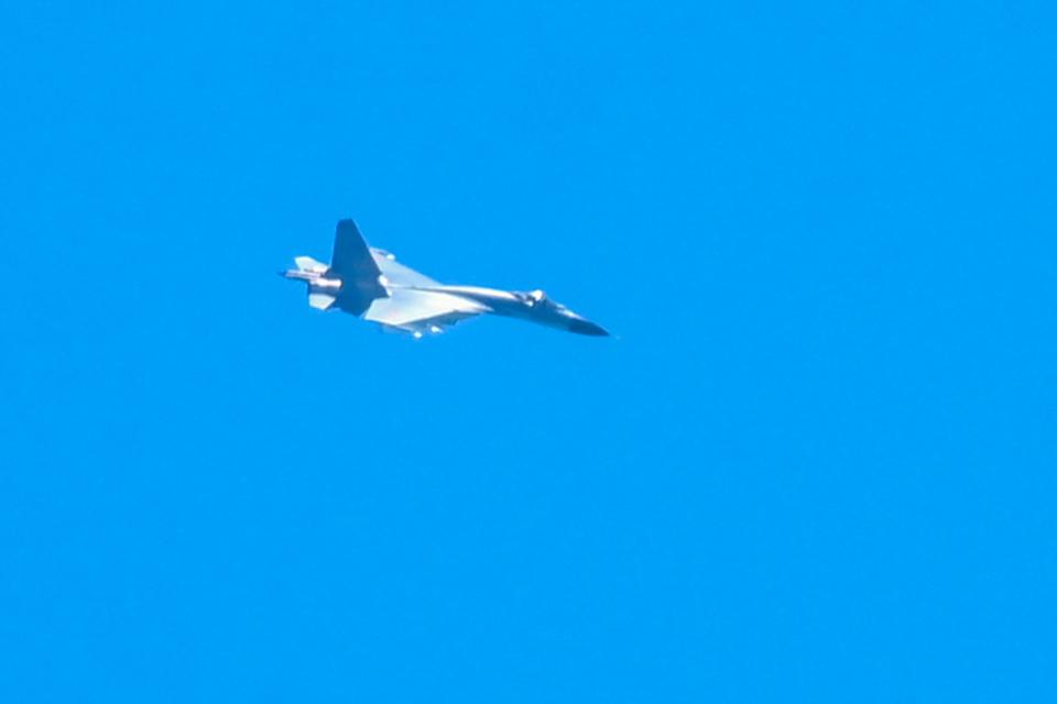 A Chinese military jet flies over Pingtan island, one of mainland China’s closest point from Taiwan, in Fujian province on 5 August 2022 (AFP via Getty Images)