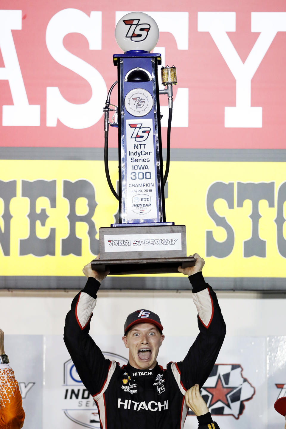 Josef Newgarden celebrates with the trophy after winning the IndyCar Series auto race Sunday, July 21, 2019, at Iowa Speedway in Newton, Iowa. (AP Photo/Charlie Neibergall)