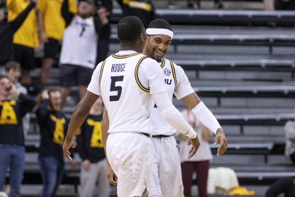 Missouri's Isiaih Mosley, right, celebrates a turnover with teammate D'Moi Hodge, left, during the second half of an NCAA college basketball game against Coastal Carolina Wednesday, Nov. 23, 2022, in Columbia, Mo. Missouri won 89-51.(AP Photo/L.G. Patterson)