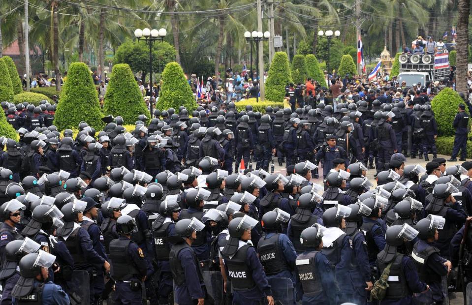 Thai policemen with full riot gears form up lines after anti-government protesters enter in to the Command Management for Peace and Order (CMPO) office during a rally Friday, Feb. 21, 2014 in Bangkok, Thailand. Angry farmers driving hundreds of tractors called off a threatened protest at Thailand's main airport Friday, offering a reprieve to the country's embattled prime minister and to travelers fearing a repeat of a major 2008 blockade of the airport. (AP Photo/Wason Wanichakorn)