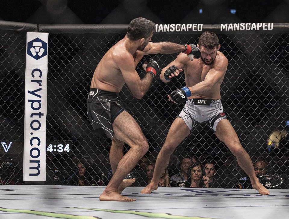 Oct 22, 2022; Abu Dhabi, UAE; Beneil Dariush (red gloves) and Mateusz Gamrot (blue gloves) during UFC 280 at Etihad Arena. Mandatory Credit: Craig Kidwell-USA TODAY Sports