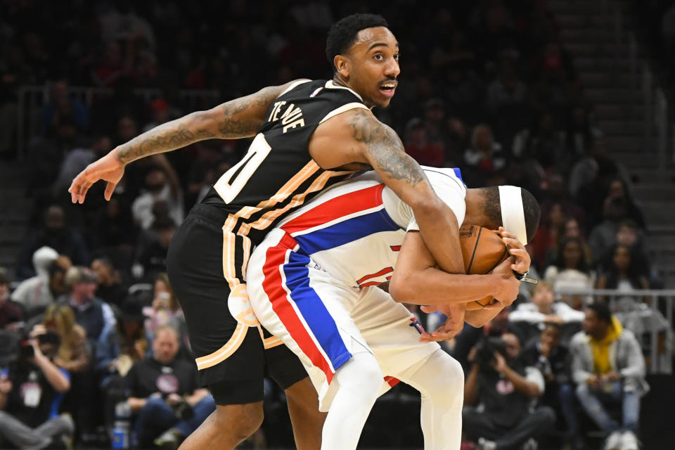 Atlanta Hawks guard Jeff Teague, left, becomes entangled with Detroit Pistons guard Tim Frazier as a jump ball is called during the second half of an NBA basketball game Saturday, Jan. 18, 2020, in Atlanta. (AP Photo/John Amis)