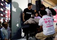 Reiwa Shinsengumi's disabled candidate for Japan's July 21 upper house election, Eiko Kimura is helped by supporters during an election rally in Tokyo